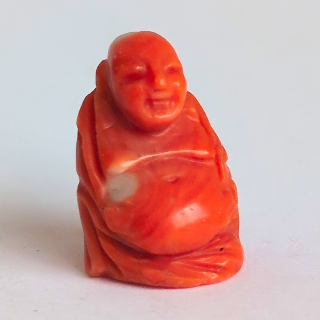 Small Carved Laughing Buddha Orange/Red pendant