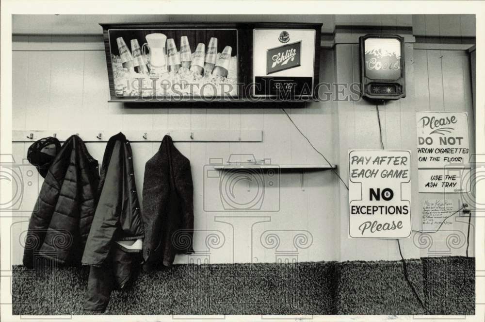1985 Press Photo Signs and coats hanging inside Independence Cue Lounge, NC