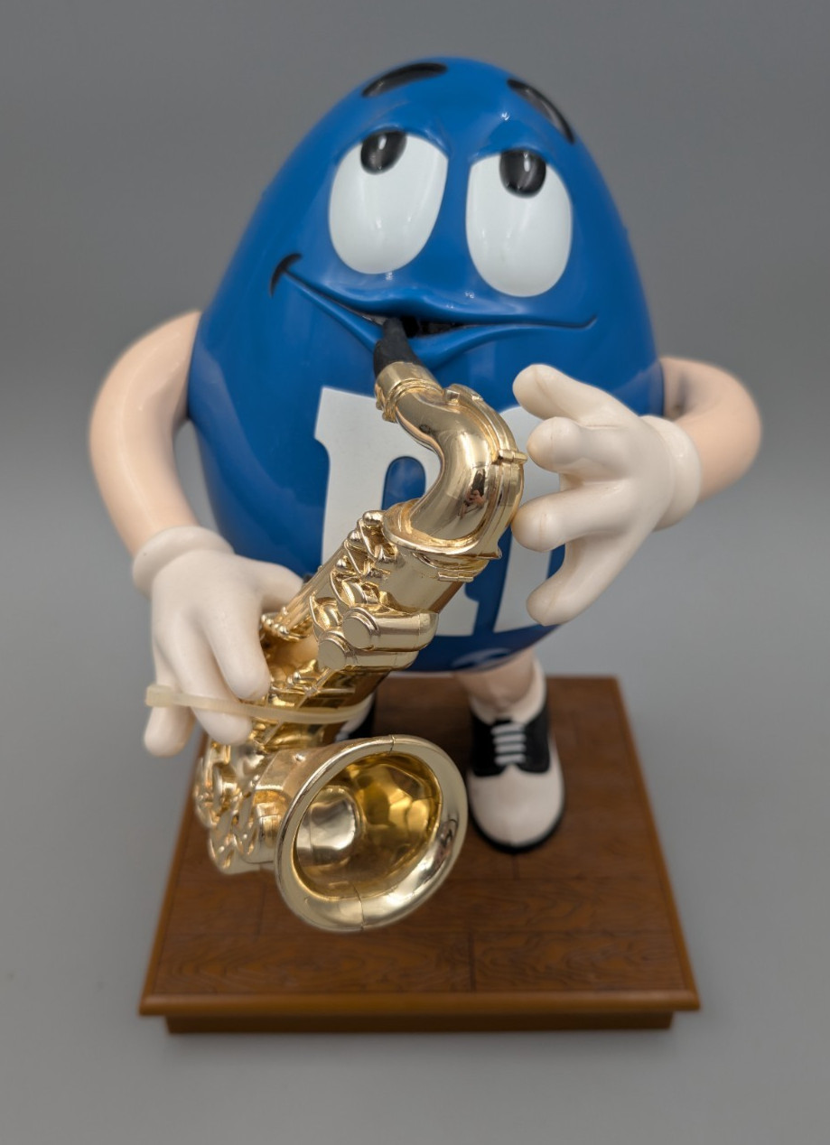 M & M\'S COLLECTIBLE - M & M Blue Peanut Playing The Saxophone/Candy Dispenser M & M\'S COLLECTIBLE - M & M Blue Peanut Playing The Saxophone/Candy Dispenser