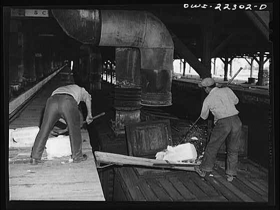 Untitled photo, : San Bernardino, California. Worker removing an air duct from