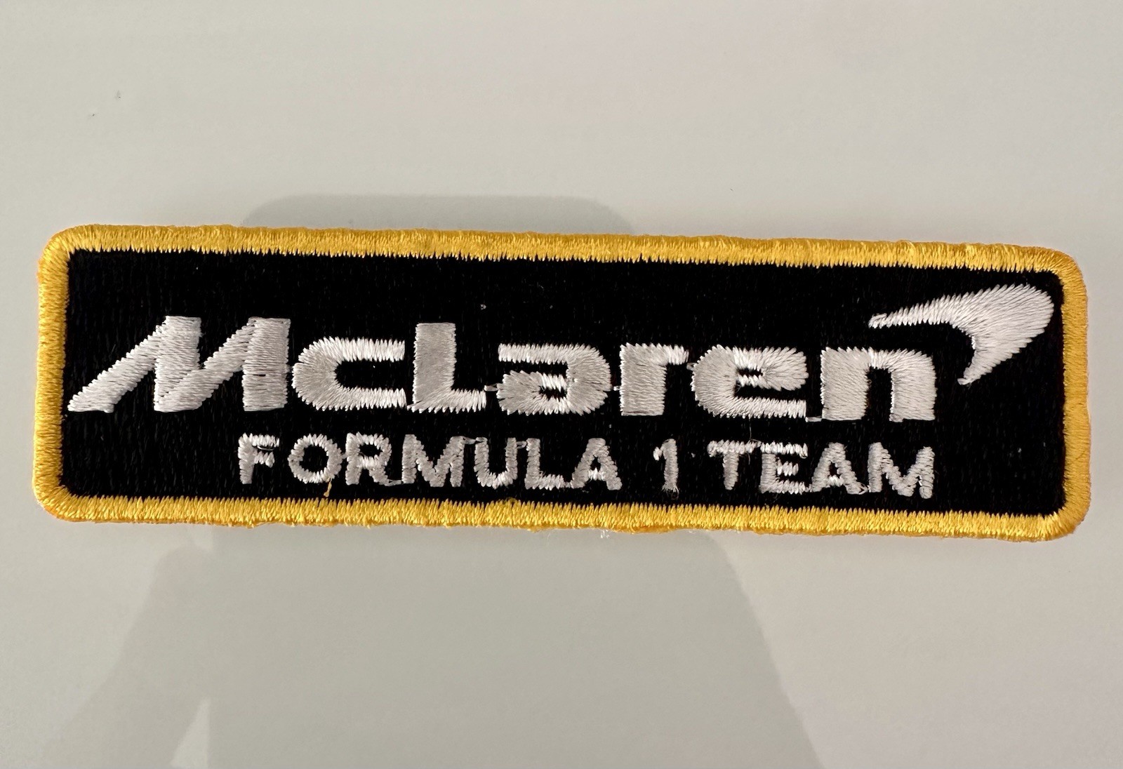 Rare McLaren Racing F1 Iron-on PATCH 1.5” H X 3” L Black Yellow