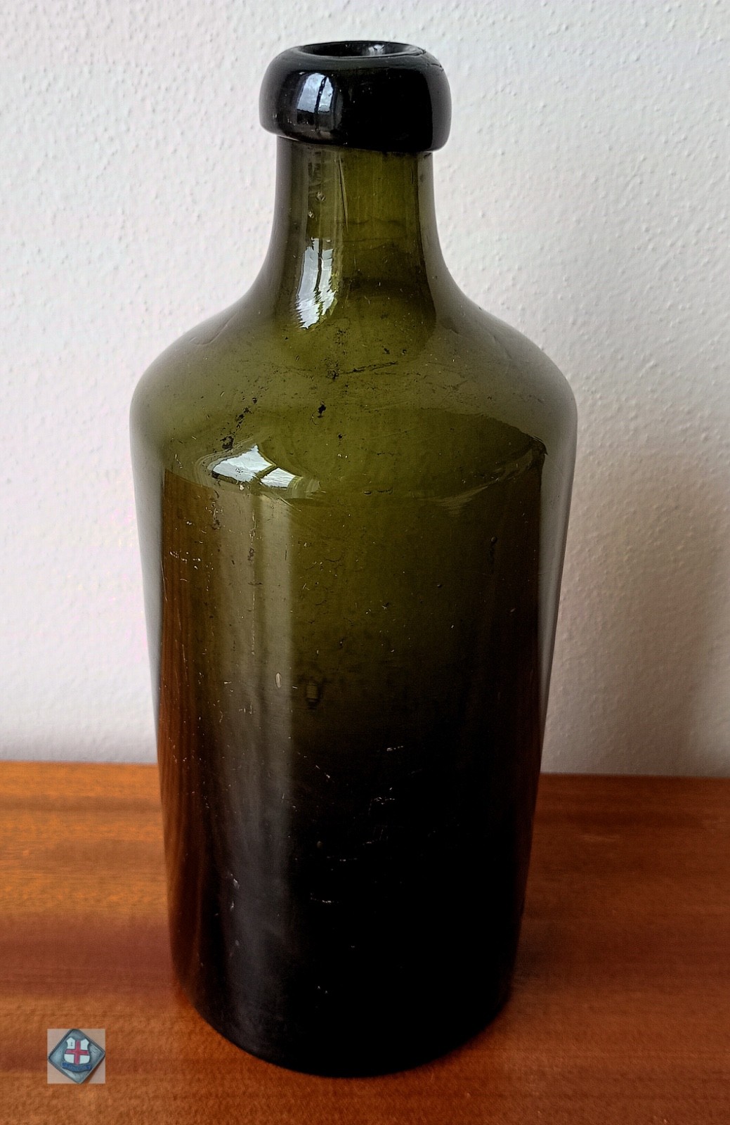 Antique bottle made of dark olive green glass (England, around 1850) Antique bottle made of dark olive green glass (England, around 1850)
