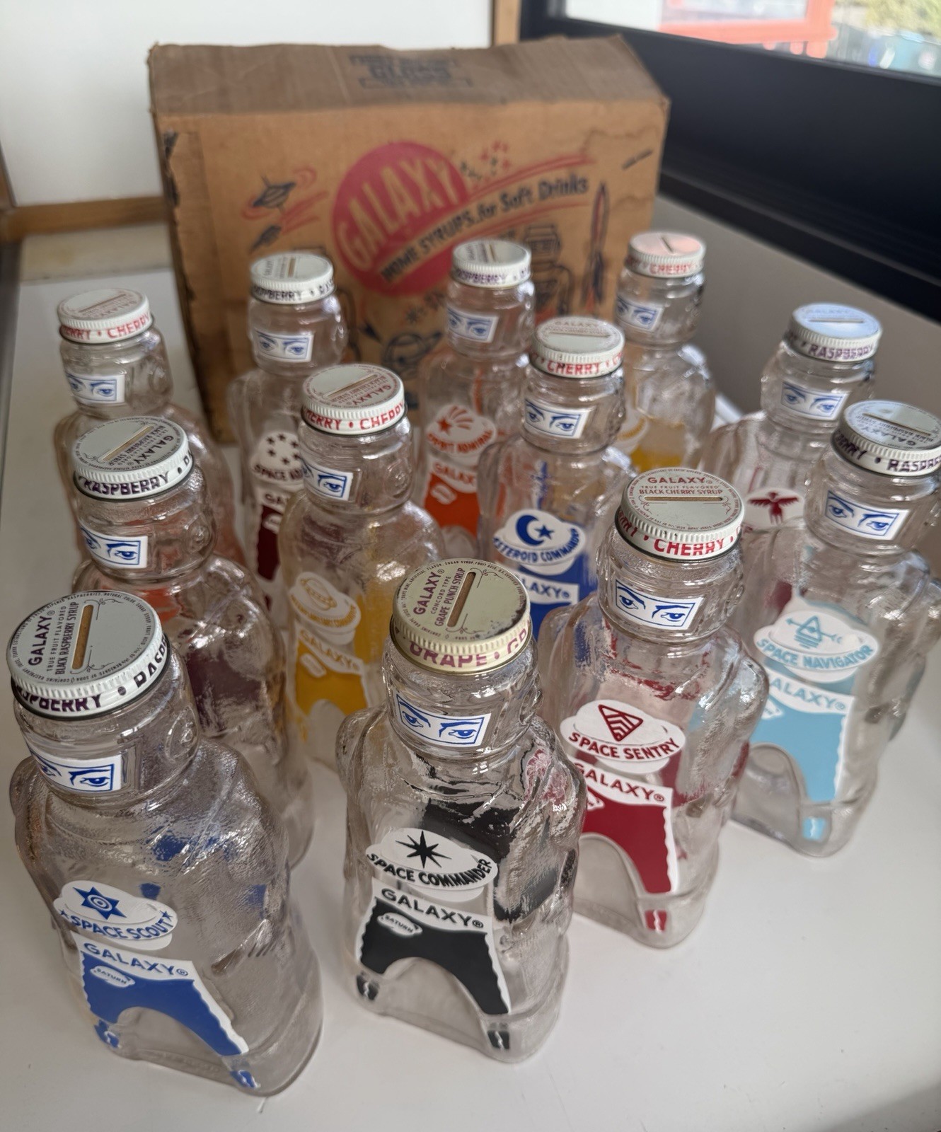 12 Galaxy Space Foods  Astronaut Syrup for Sodas 1953 Coin Bank Bottles.