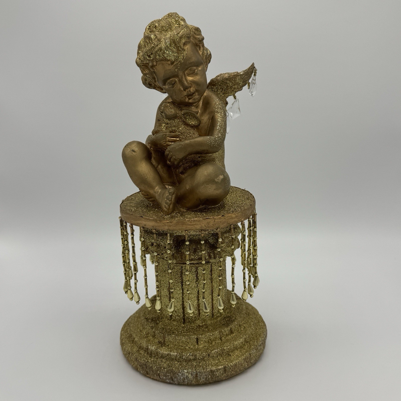 Cherub Sitting On Glittery Golden Beaded Pedestal Holding Rabbit Figure Decor Cherub Sitting On Glittery Golden Beaded Pedestal Holding Rabbit Figure Decor