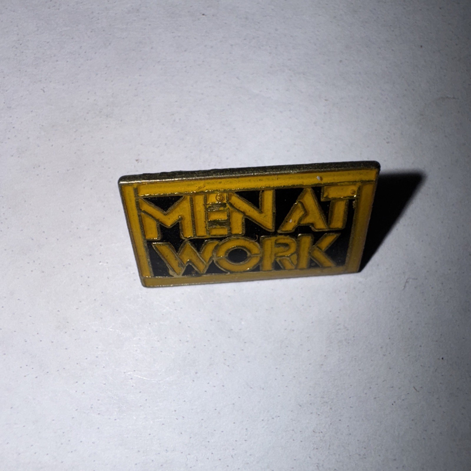 Men at Work vintage enamel Rock lapel or hat pin. 