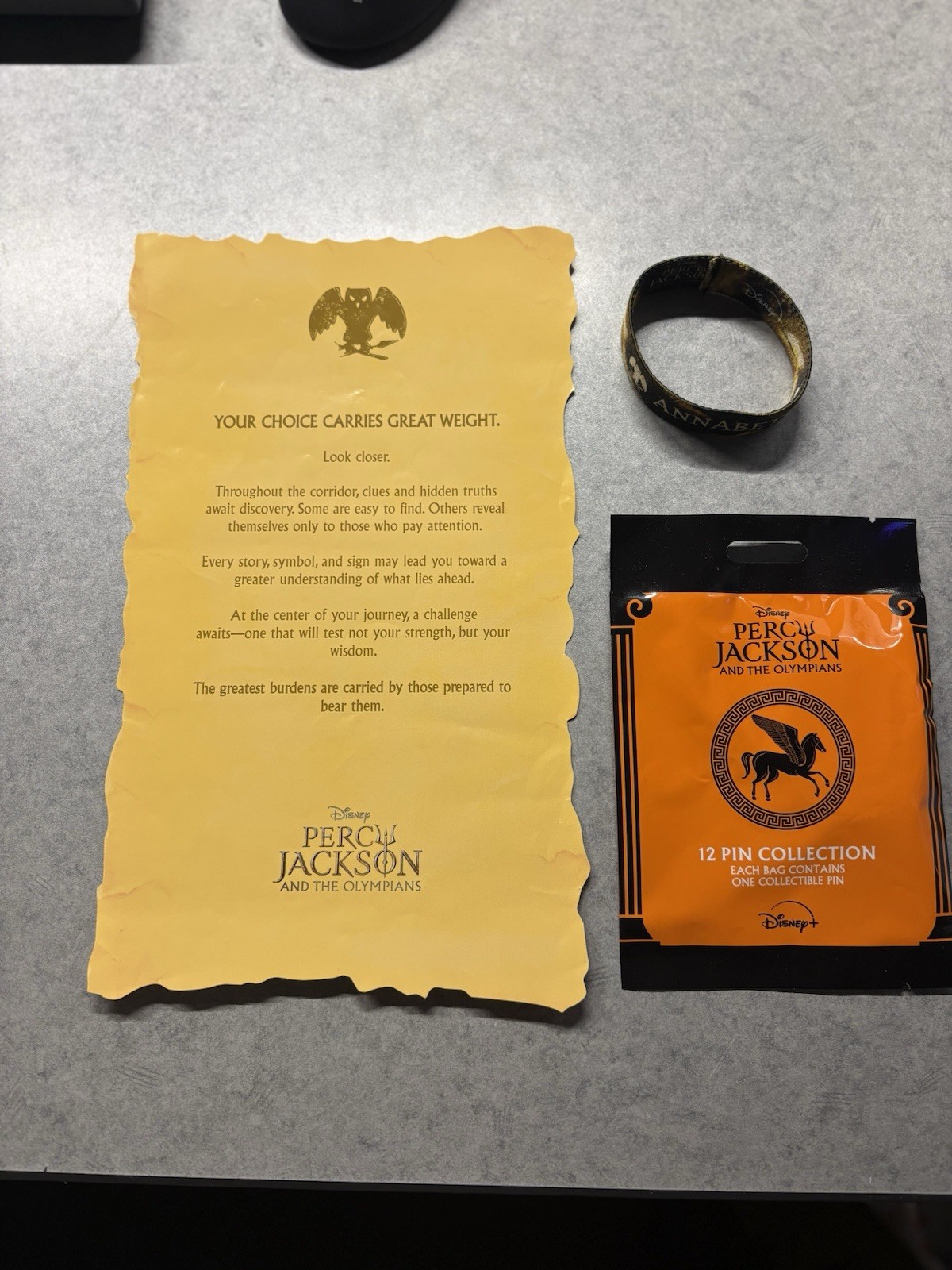 2026 SDCC PERCY JACKSON BLIND BAG PIN, ANNABETH WRISTBAND & ATHENA YELLOW SCROLL 2026 SDCC PERCY JACKSON BLIND BAG PIN, ANNABETH WRISTBAND & ATHENA YELLOW SCROLL