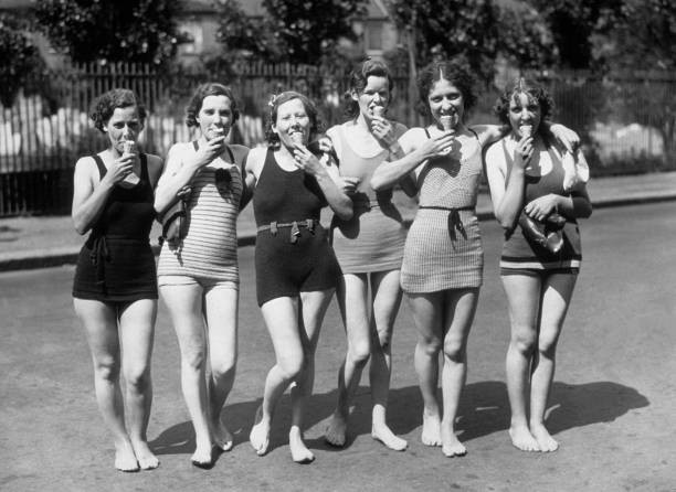 young women, dressed swimming costumes, eating ice-creams during h - 1937 Photo young women, dressed swimming costumes, eating ice-creams during h - 1937 Photo