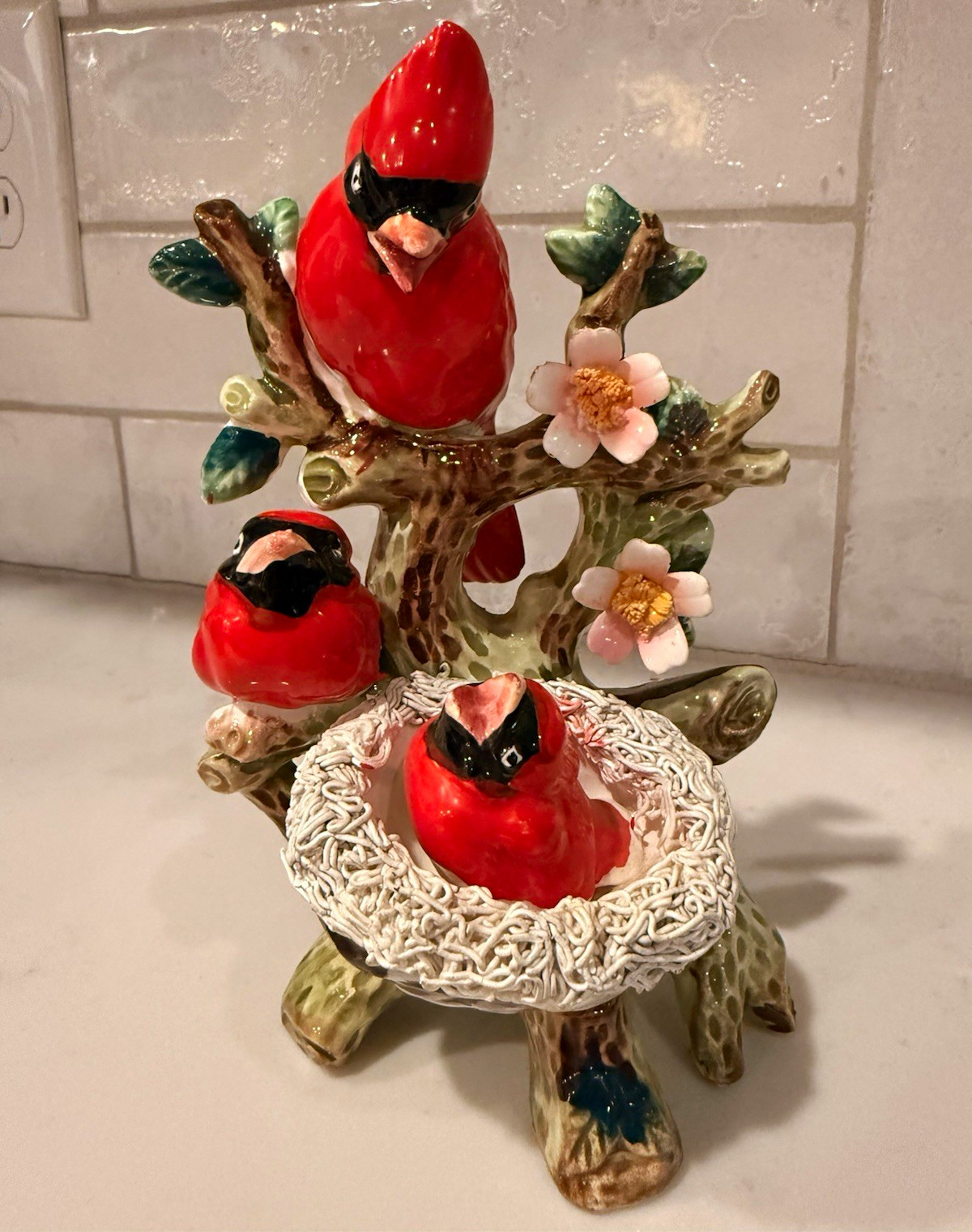 This is a mid-20th century Napco ceramic cardinal family and nest figurine.