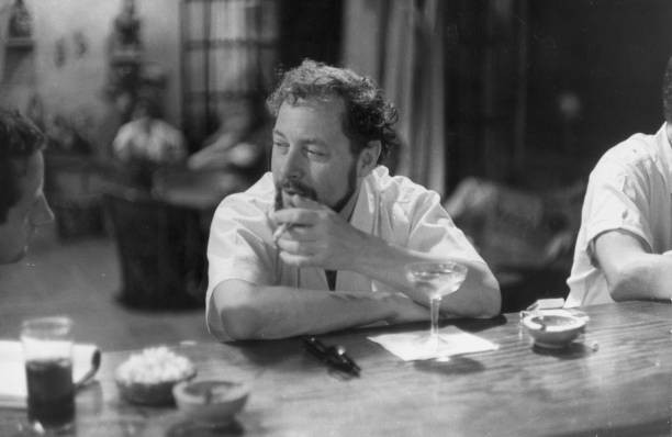 American playwright Tennessee Williams seated at a bar smoking a c- Old Photo