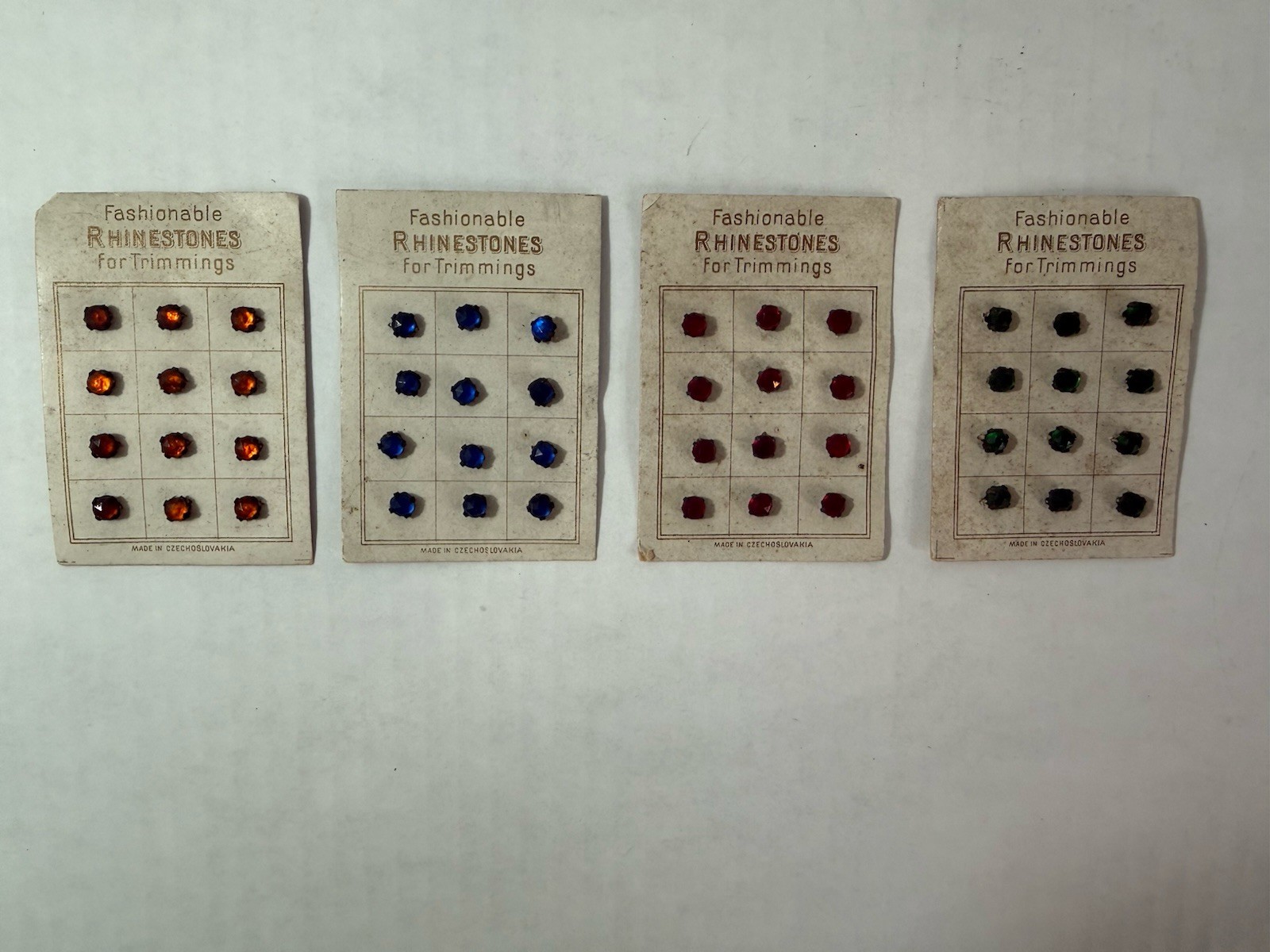 4 Vtg Fashionable Rhinestones For Trimmings On Card Czech Red Green Amber Blue