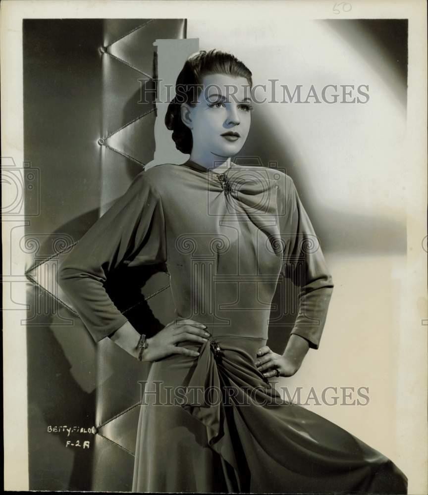 1944 Press Photo Actress Betty Field Models Orange Crepe Gown with Side Drapes 1944 Press Photo Actress Betty Field Models Orange Crepe Gown with Side Drapes