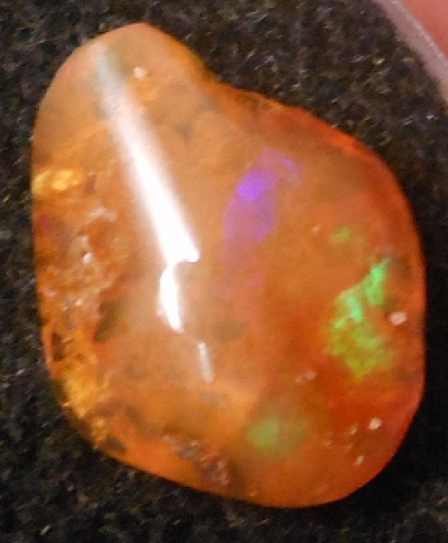 4.60ct Orange Mexican Fire Opal Blazing Greens and Purples 16mm x 12.6mm x 5.2mm 4.60ct Orange Mexican Fire Opal Blazing Greens and Purples 16mm x 12.6mm x 5.2mm