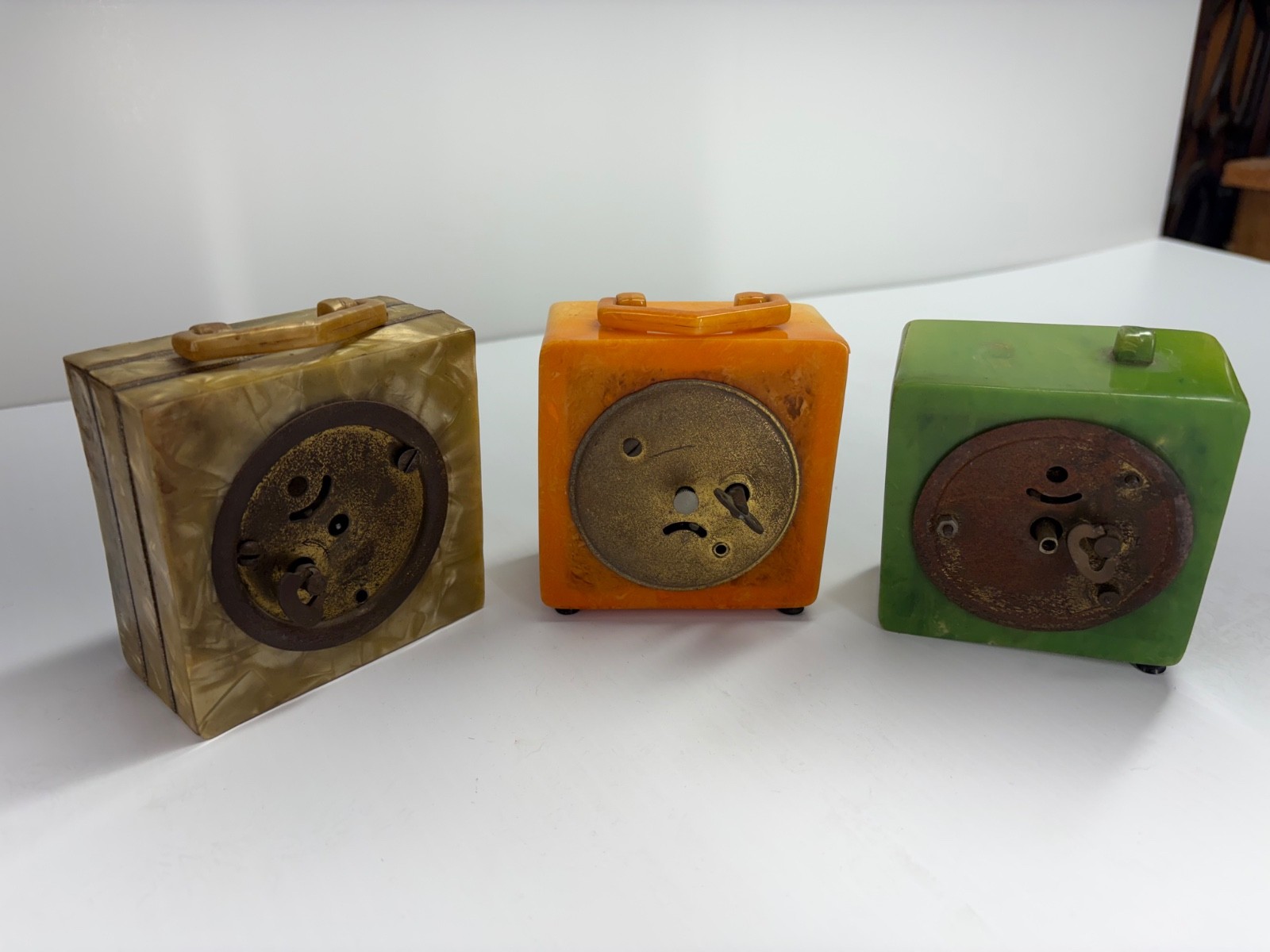 Appear to be catalin bakelite clocks. You be the judge