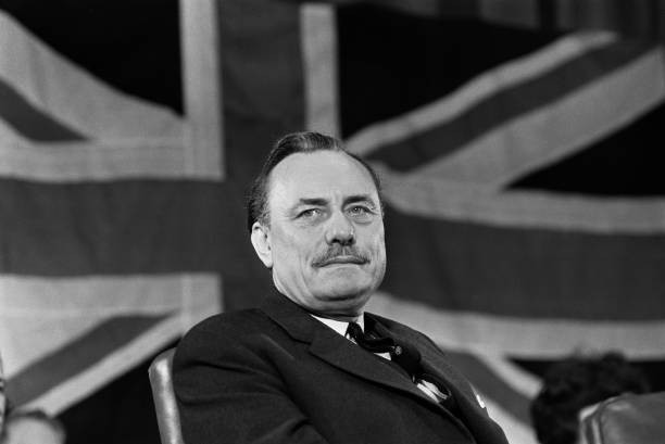 Conservative Party politician Enoch Powell seated in front of a Br- Old Photo