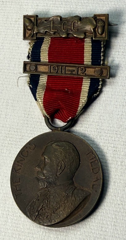 Antique 1911 King\'s Medal London with red/white/blue ribbon. Antique 1911 King\'s Medal London with red/white/blue ribbon.