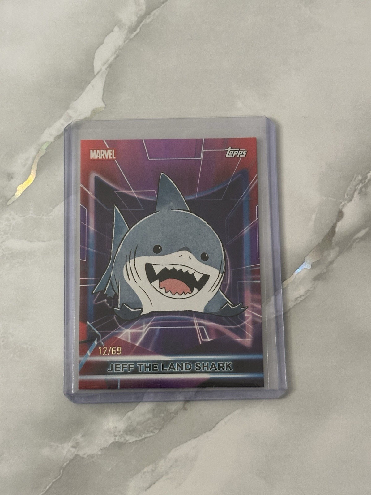 2026 Topps Marvel Neon JEFF THE LAND SHARK Diamante /69 Purple 2026 Topps Marvel Neon JEFF THE LAND SHARK Diamante /69 Purple