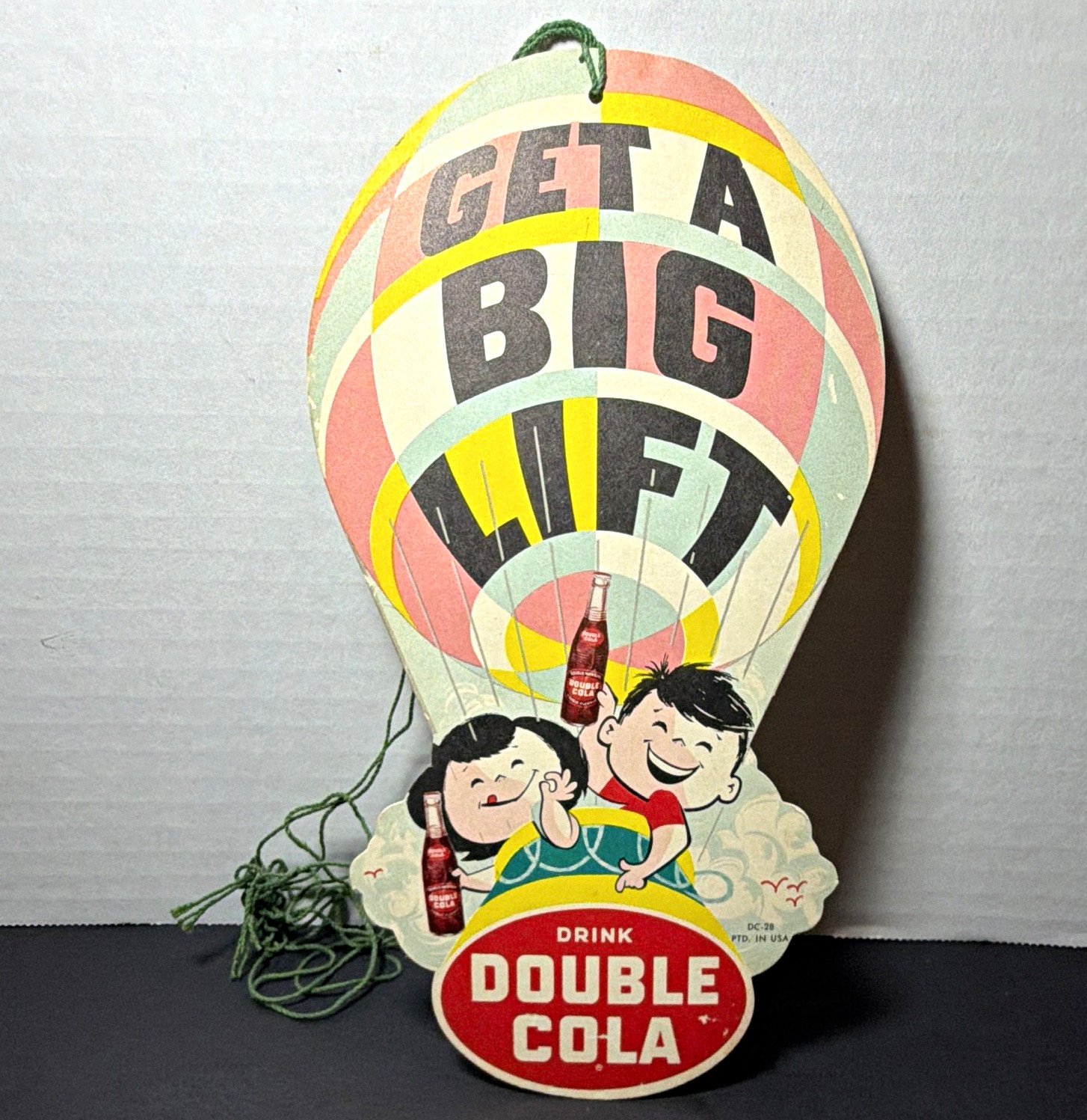 Double Cola Vintage Hanging Die-Cut Soda Sign “Get a Big Lift” DC-28 FAN PULL Double Cola Vintage Hanging Die-Cut Soda Sign “Get a Big Lift” DC-28 FAN PULL