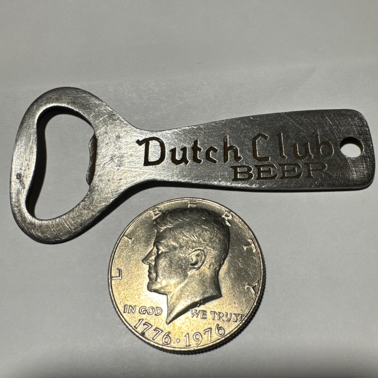 DUTCH CLUB BEER VINTAGE BOTTLE OPENER & 1976 Kennedy Half Dollar Coin DUTCH CLUB BEER VINTAGE BOTTLE OPENER & 1976 Kennedy Half Dollar Coin