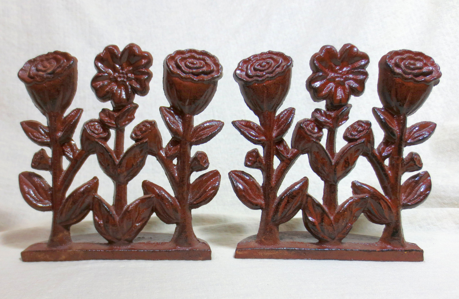 Pair Antique Japanned Cast Iron Floral Doorstops 3 Flower Blooms Half Round Base
