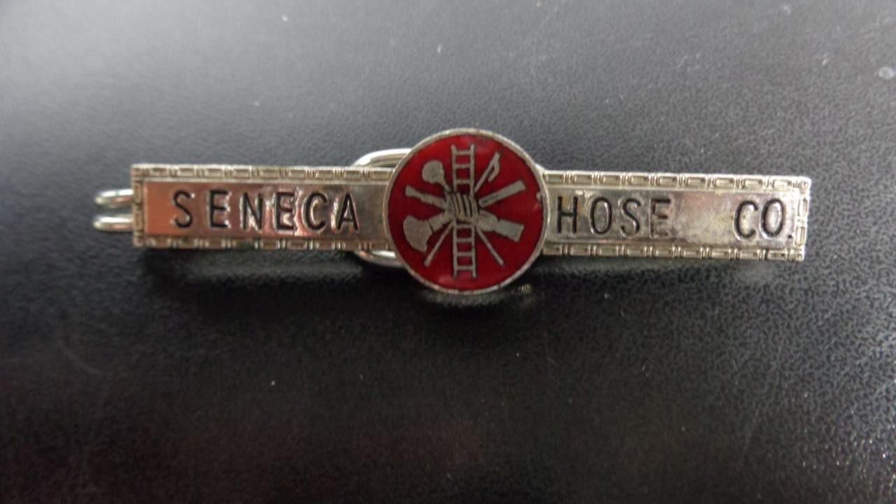 VINTAGE SENECA HOSE CO. TIE CLIP WITH RED ENAMEL FIREFIGHTER EMBLEM AT CENTER