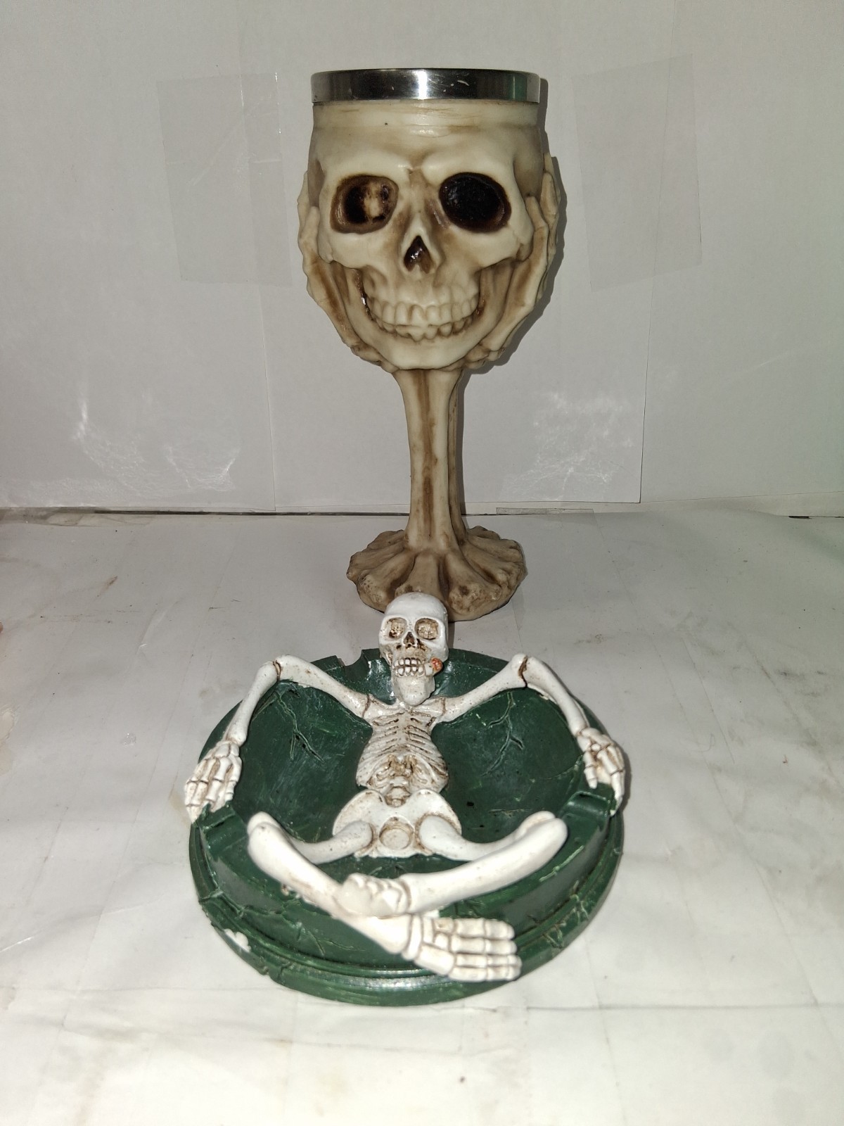 Ebros Gift ossuary skeletal claw hand skull wine goblet and a skeleton Ashtray.