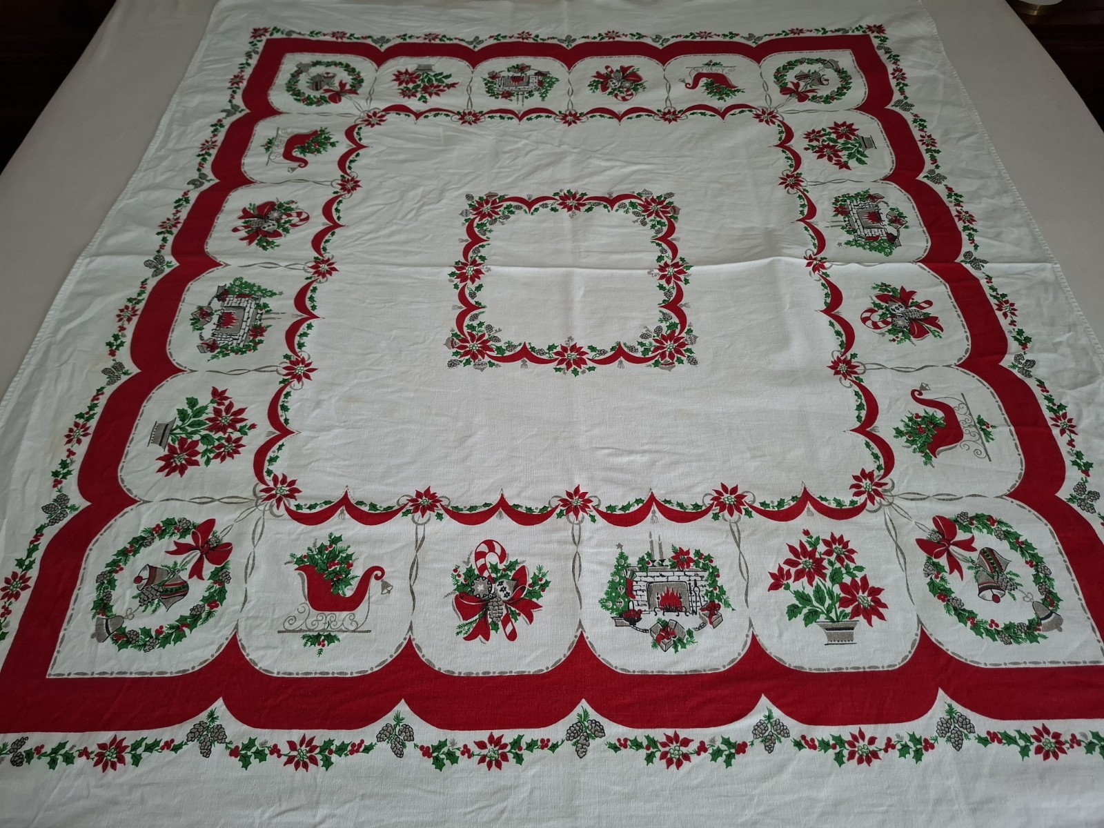 Christmas Themed VTG Tablecloth 45x49 Xmas Wreaths Holly Poinsettia Sleigh 