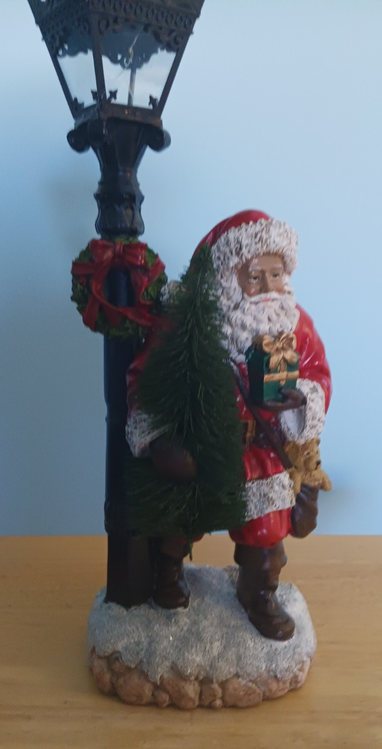 Santa Claus standing next to lamp pole, lights up 18in x 6.25in x 5in