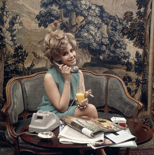 Young woman speaking over phone holding a glass a cigarette Italy - Old Photo