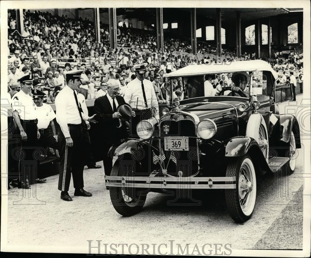 Press Photo An old time automobile arrives at a stadium - net10631 Press Photo An old time automobile arrives at a stadium - net10631