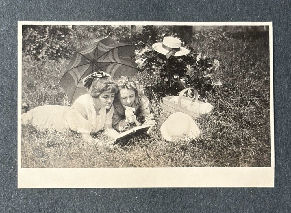 Antique Snapshot Photo 2 Lovely Young Women Laying On Grass Looking At Book
