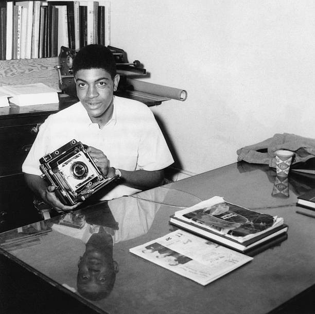 Prairie View A&M student poses a photograph holding a Graflex Crow- Old Photo
