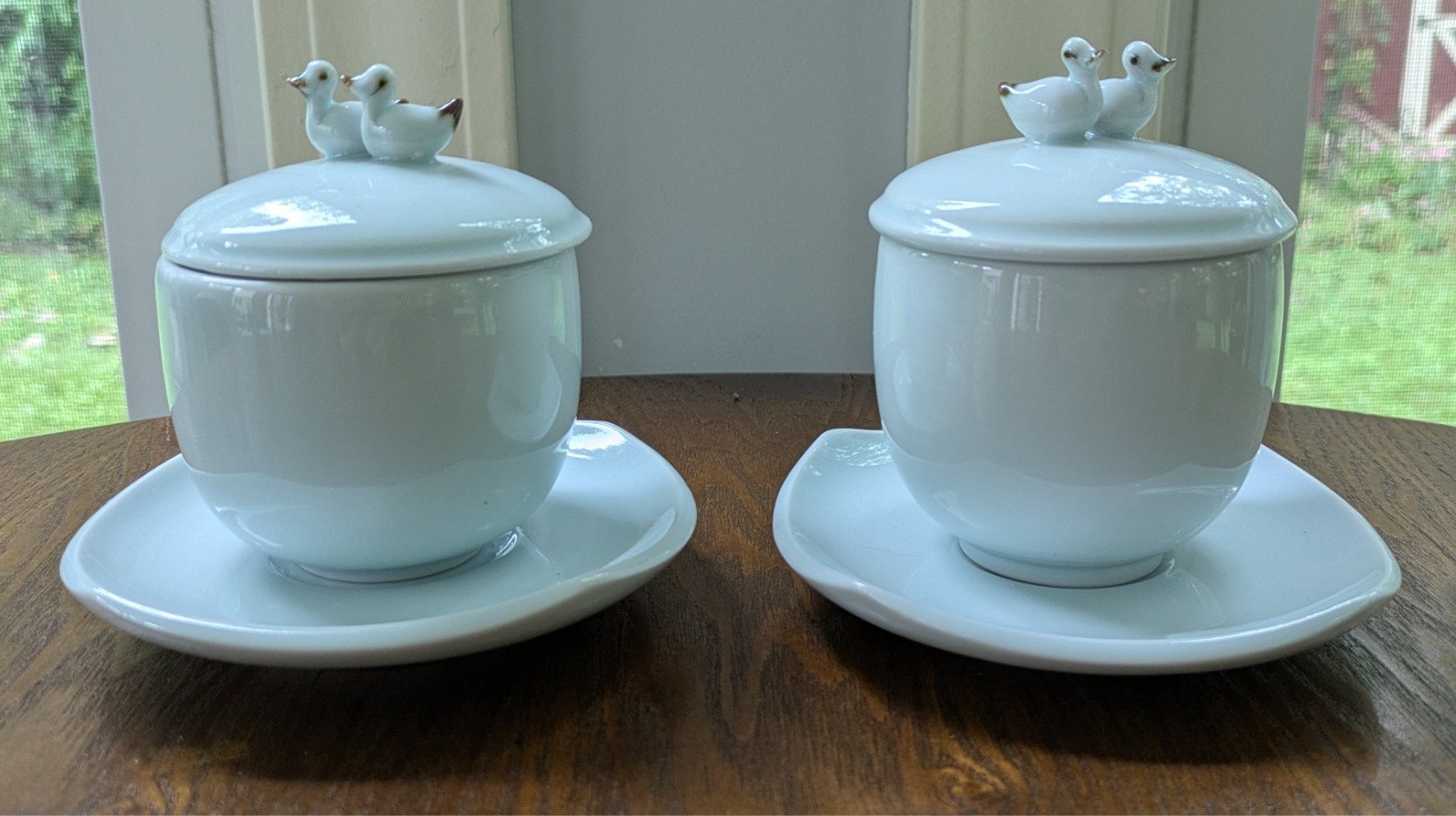 Vtg pair of Japanese celadon lidded tea cups & saucers, with twin duck finial Vtg pair of Japanese celadon lidded tea cups & saucers, with twin duck finial