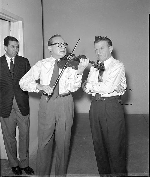 US comedian actor Jack Benny plays his trademark violin while come- Old Photo