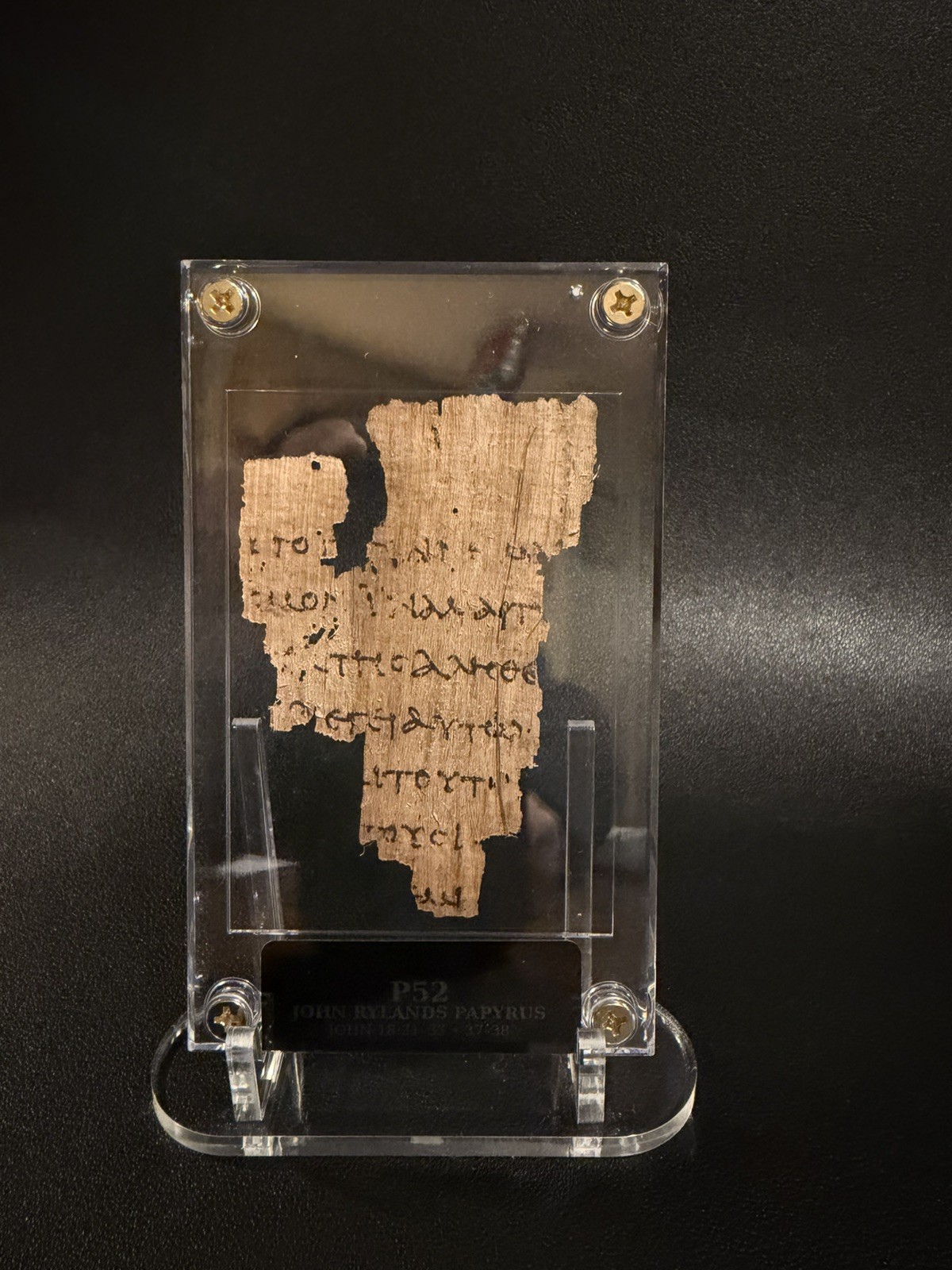 P52 John Rylands Papyrus. Gospel of John. Biblical manuscript. Hand Distressed P52 John Rylands Papyrus. Gospel of John. Biblical manuscript. Hand Distressed
