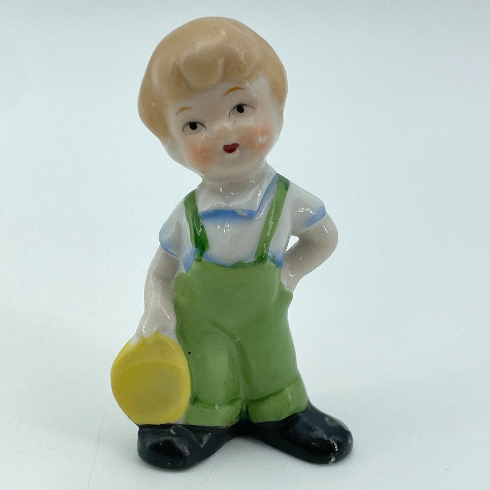 JAPAN Vintage Boy Porcelain Figurine Green Overalls Yellow Hat Decor 3.5in