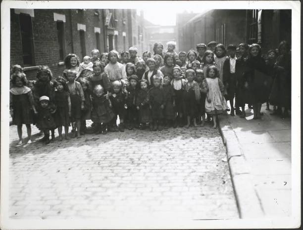 Poor children in a street in Whitechapel in 1911 London OLD PHOTO