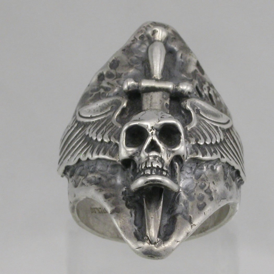 Winged skull with dagger through head silver ring