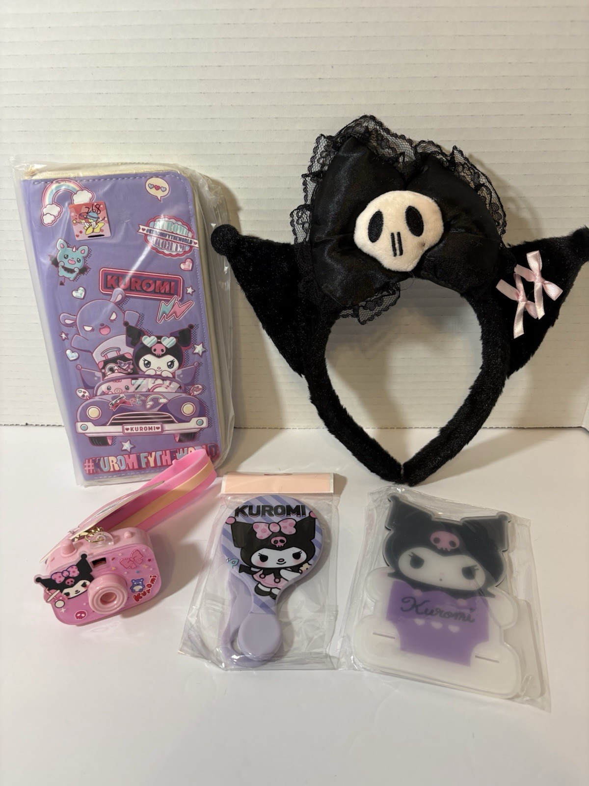 Kuromi Bundle Bow Headband, Wallet, Camera Key Chain, Mirror/comb, & Stand Kuromi Bundle Bow Headband, Wallet, Camera Key Chain, Mirror/comb, & Stand