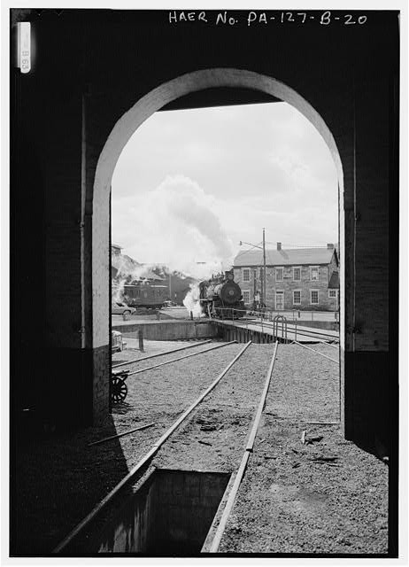 20. VIEW NORTH TO SOUTH, LOCOMOTIVE NO. 15 AND TURNTABLE FRAMED BY ROUNDHOUSE -