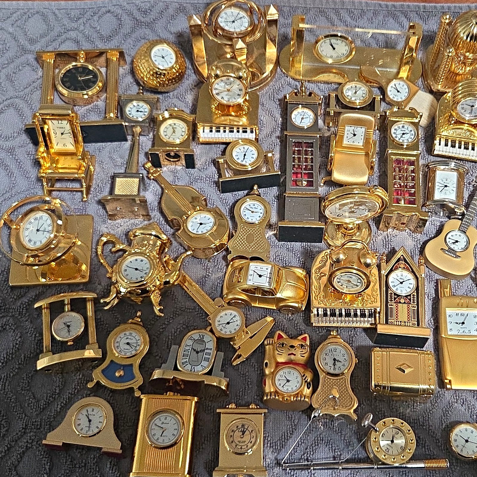 Assorted Lot Of 57 Mini Brass Desk, Mantel & Shelf Clocks, Various Styles Assorted Lot Of 57 Mini Brass Desk, Mantel & Shelf Clocks, Various Styles