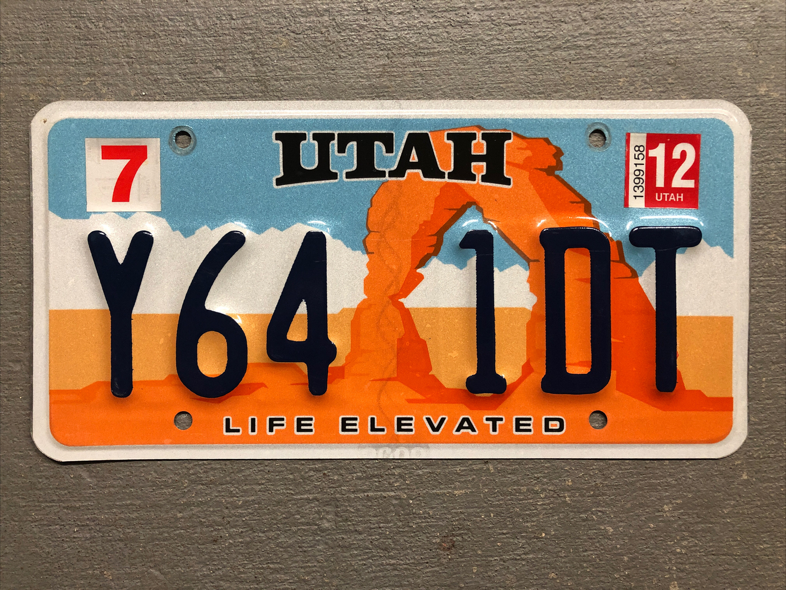 UTAH LICENSE PLATE ARCH-LIFE ELEVATED RANDOM LETTERS/NUMBERS FAIR CONDITION..
