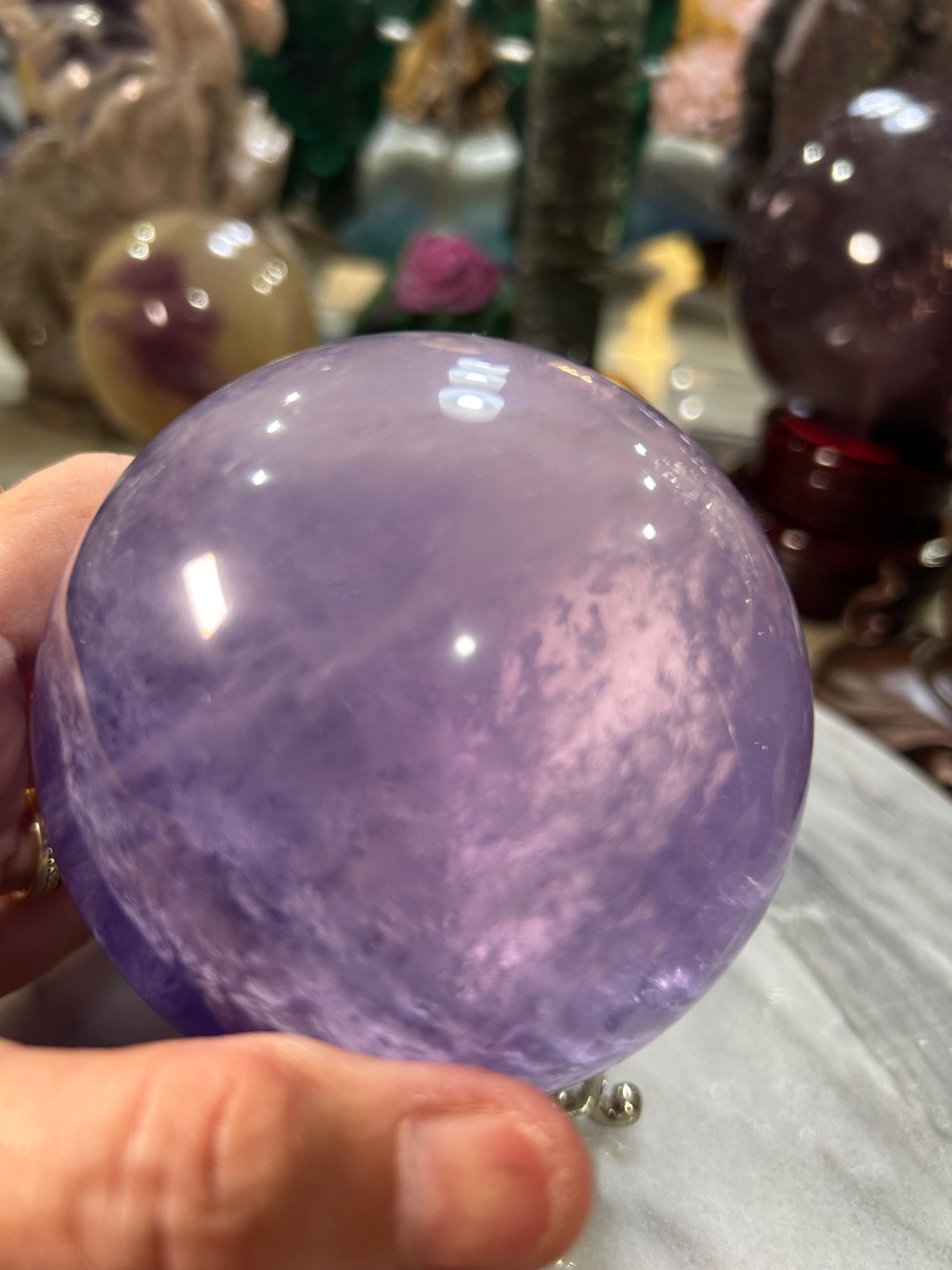 Purple flourite  sphere  with phantoms on stand 3.33”