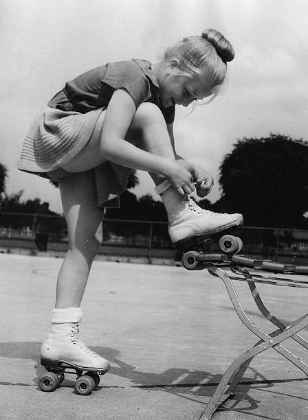 Girl from the Berlin Roller Skating Club laces up roller skates 1952 1953 Photo Girl from the Berlin Roller Skating Club laces up roller skates 1952 1953 Photo
