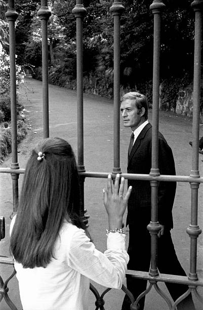 Woman looking beloved man behind a gate There no future this love - Old Photo