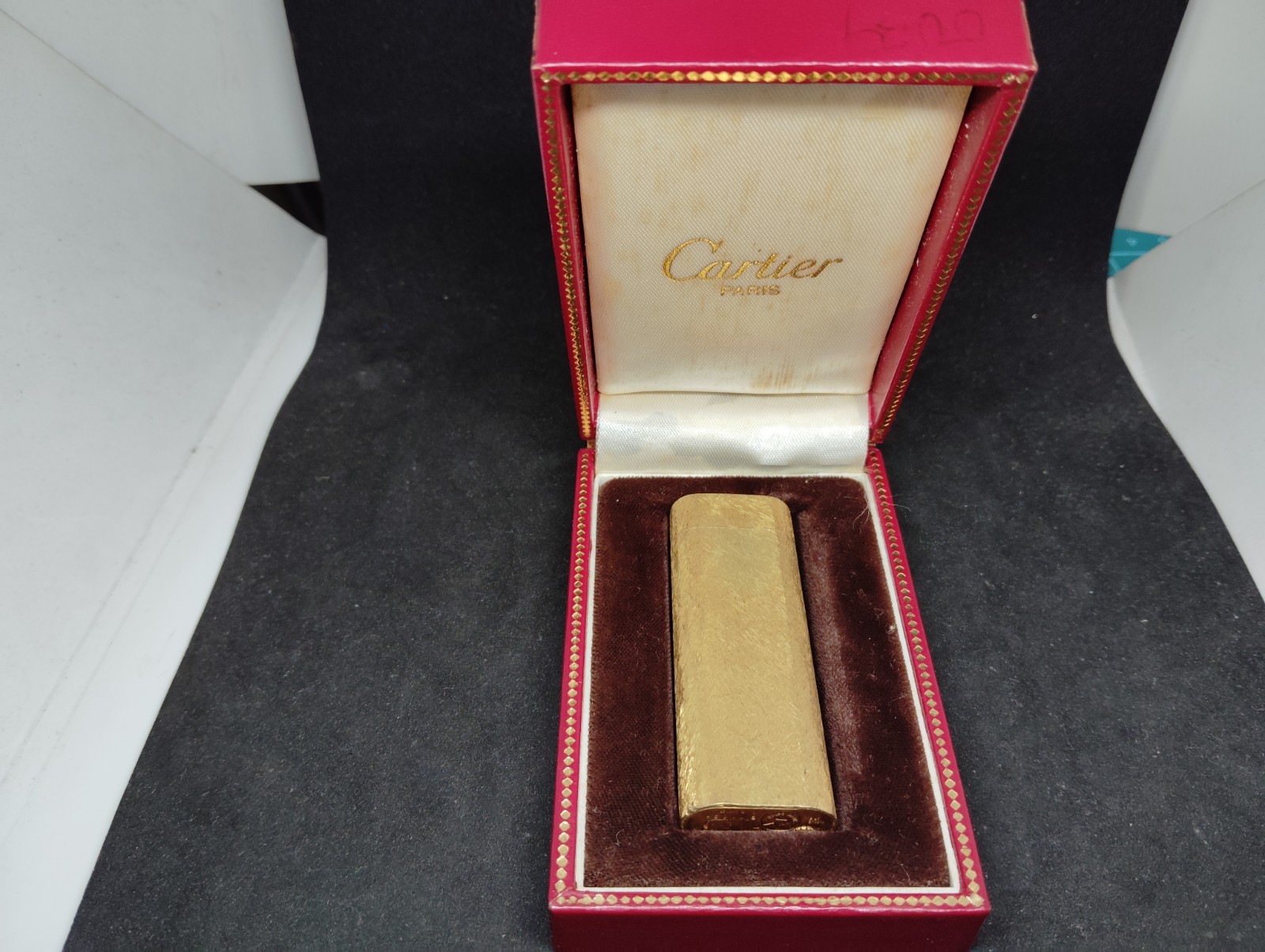 Vintage Cartier gas lighter Gold with an all-over pattern oval with box.
