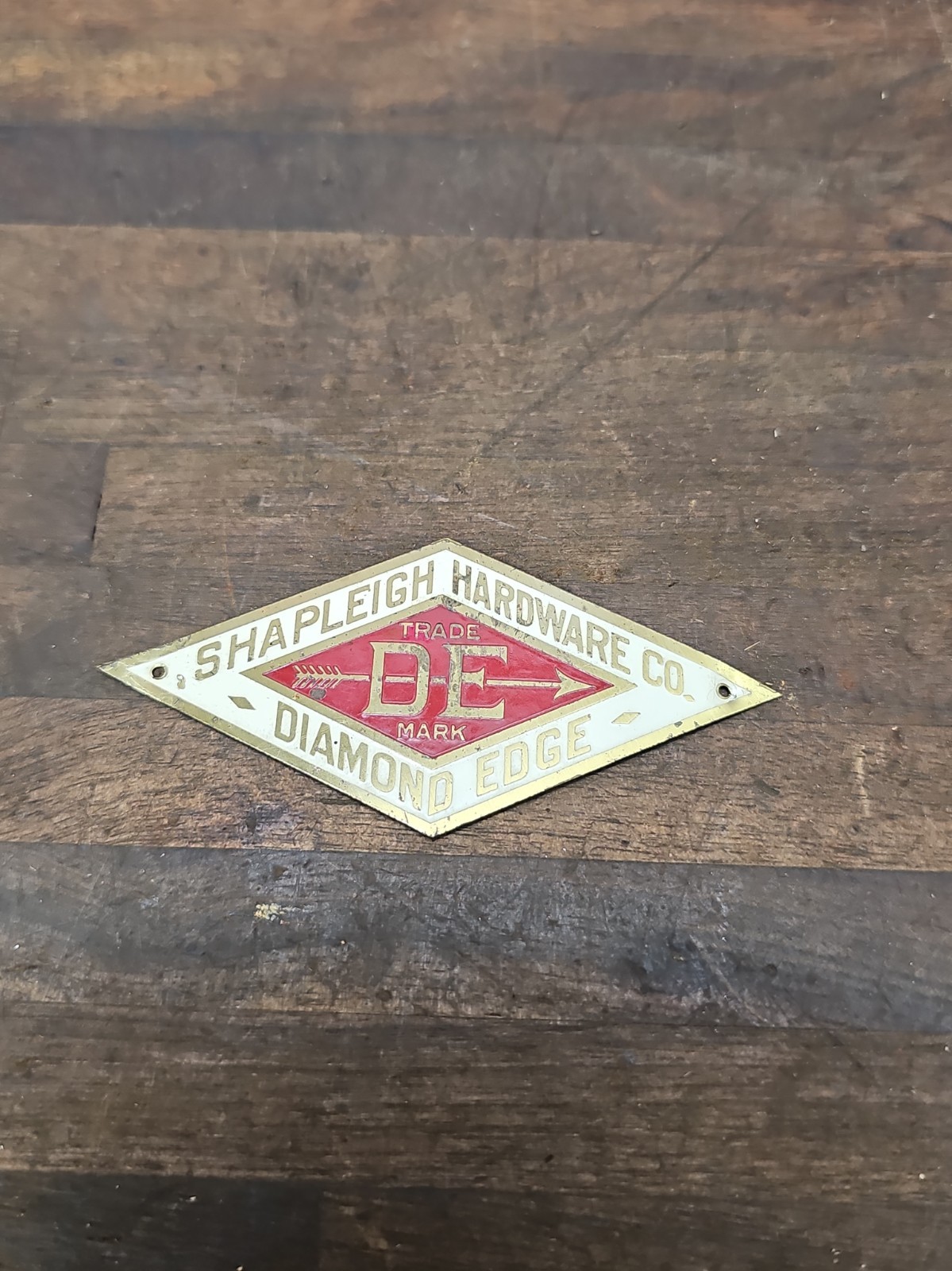 A183- Antique Shapleigh Hardware Co Diamond Edge DE Brass Advertising Emblem