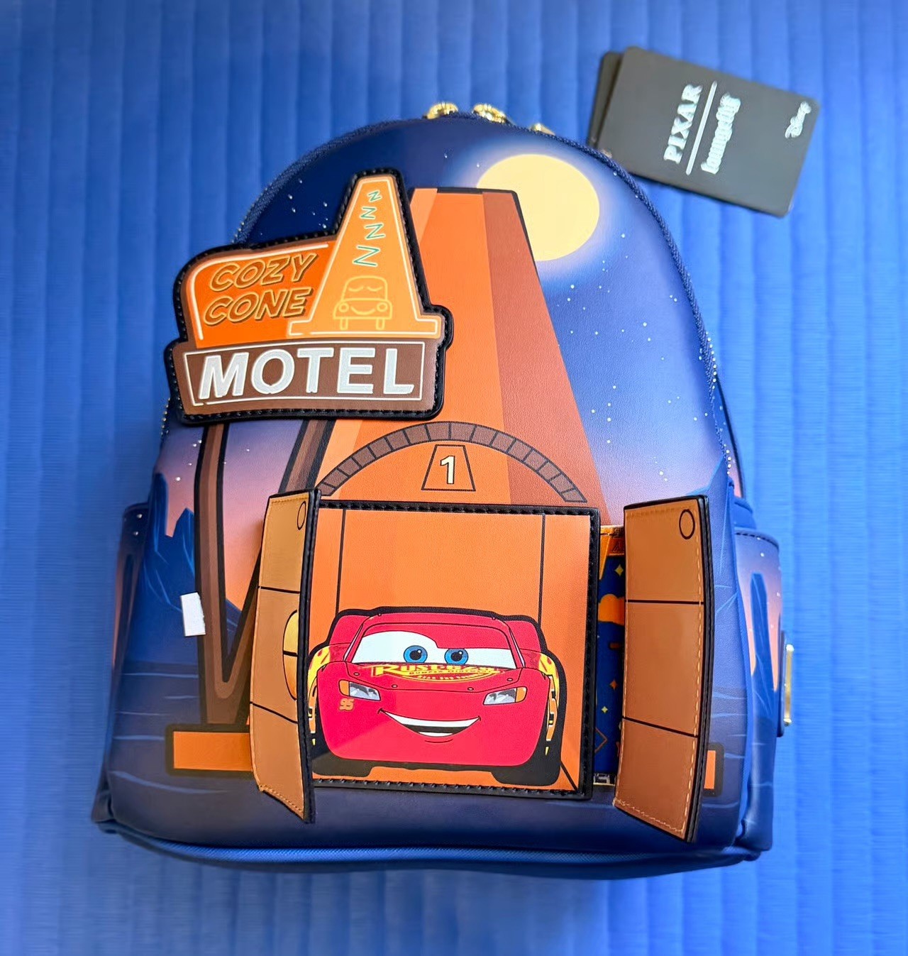 NEW LOUNGEFLY Pixar Cars Cozy Cone Motel Glow Mini Backpack **NEW DROP** NEW LOUNGEFLY Pixar Cars Cozy Cone Motel Glow Mini Backpack **NEW DROP**