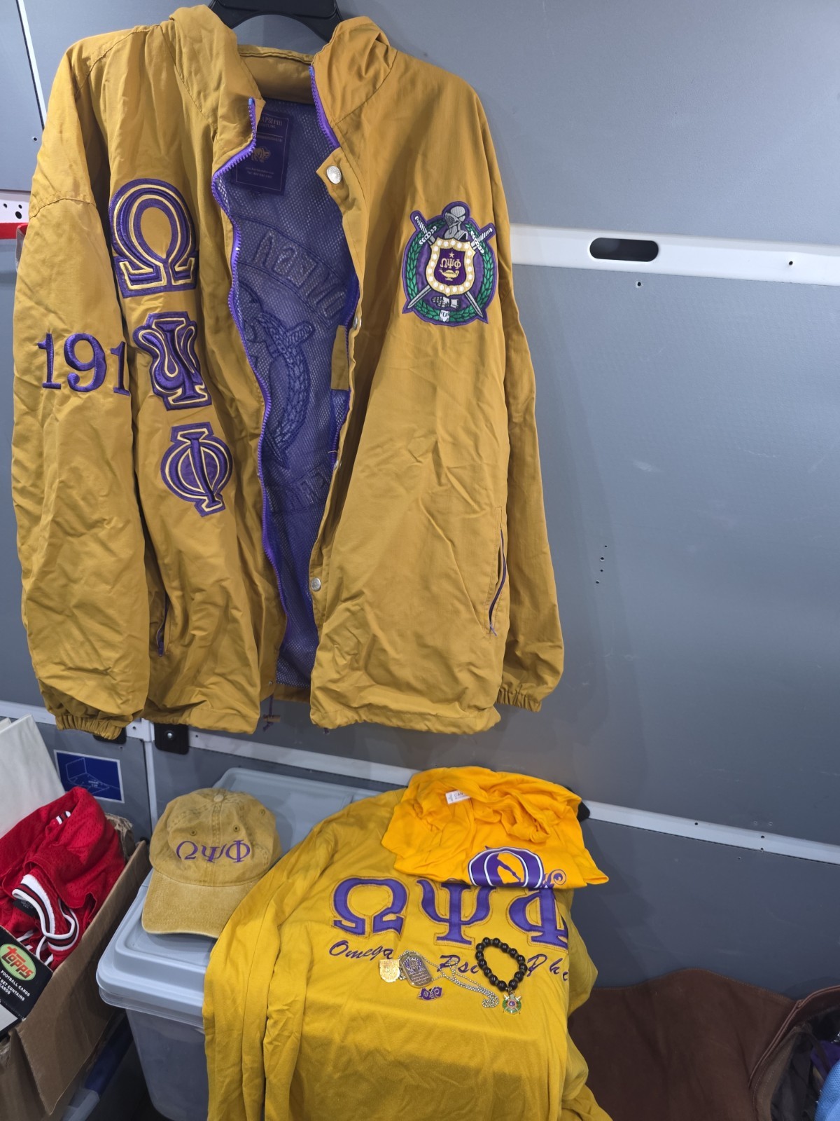 ​Omega Psi Phi Fraternity Mega Lot - Jacket, Crewneck, T-Shirt, Hat & Jewelry