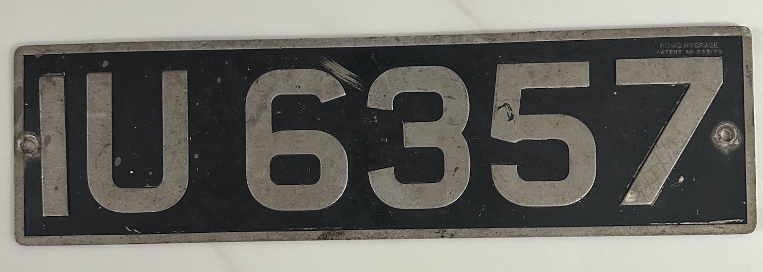 1940-50’s British Embossed License Plate IU 6357 made by Homo Hygrade 18” x 5”