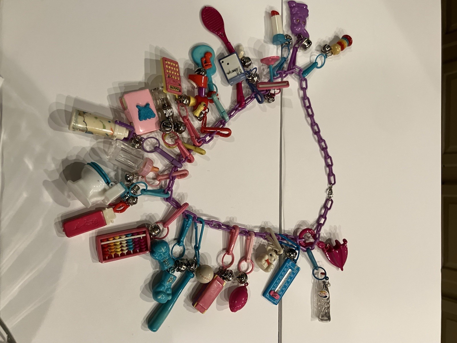 Vintage 80s Plastic Bell Charm Necklace 24 Charms Calculator Toilet Pinball Toy